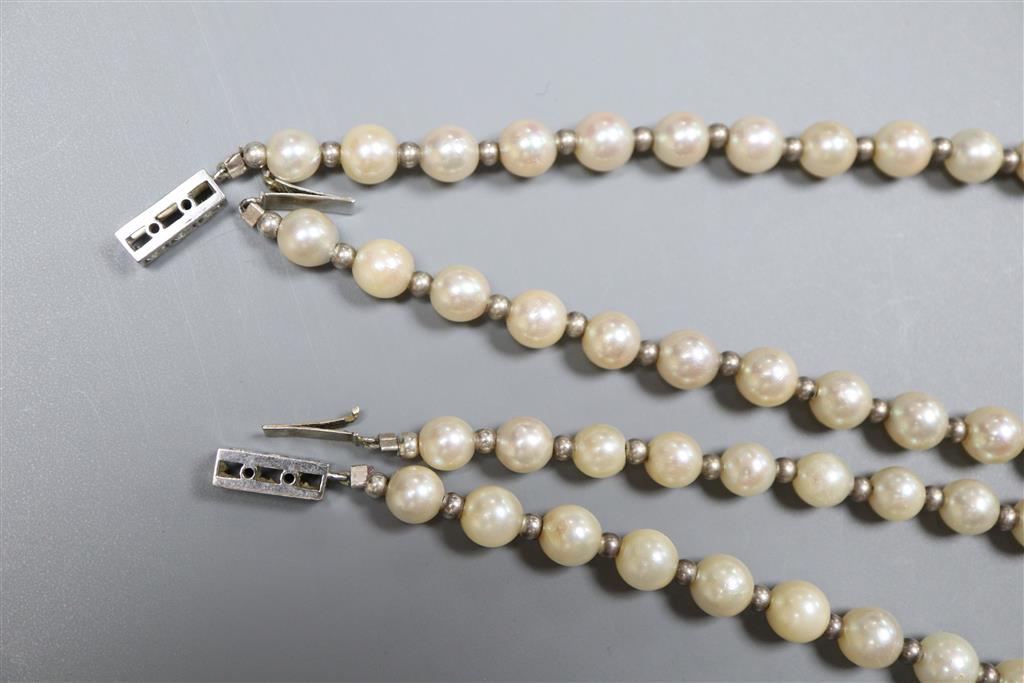 Two similar French silver strand cultured pearl necklaces with diamond set white metal( French 18ct poincon mark) clasps,